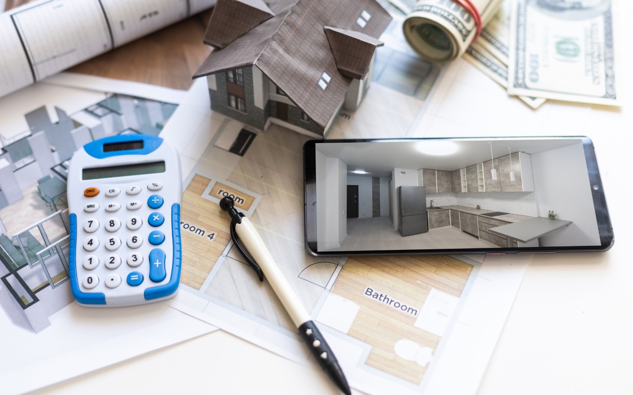 Calculator and floor plans on a table