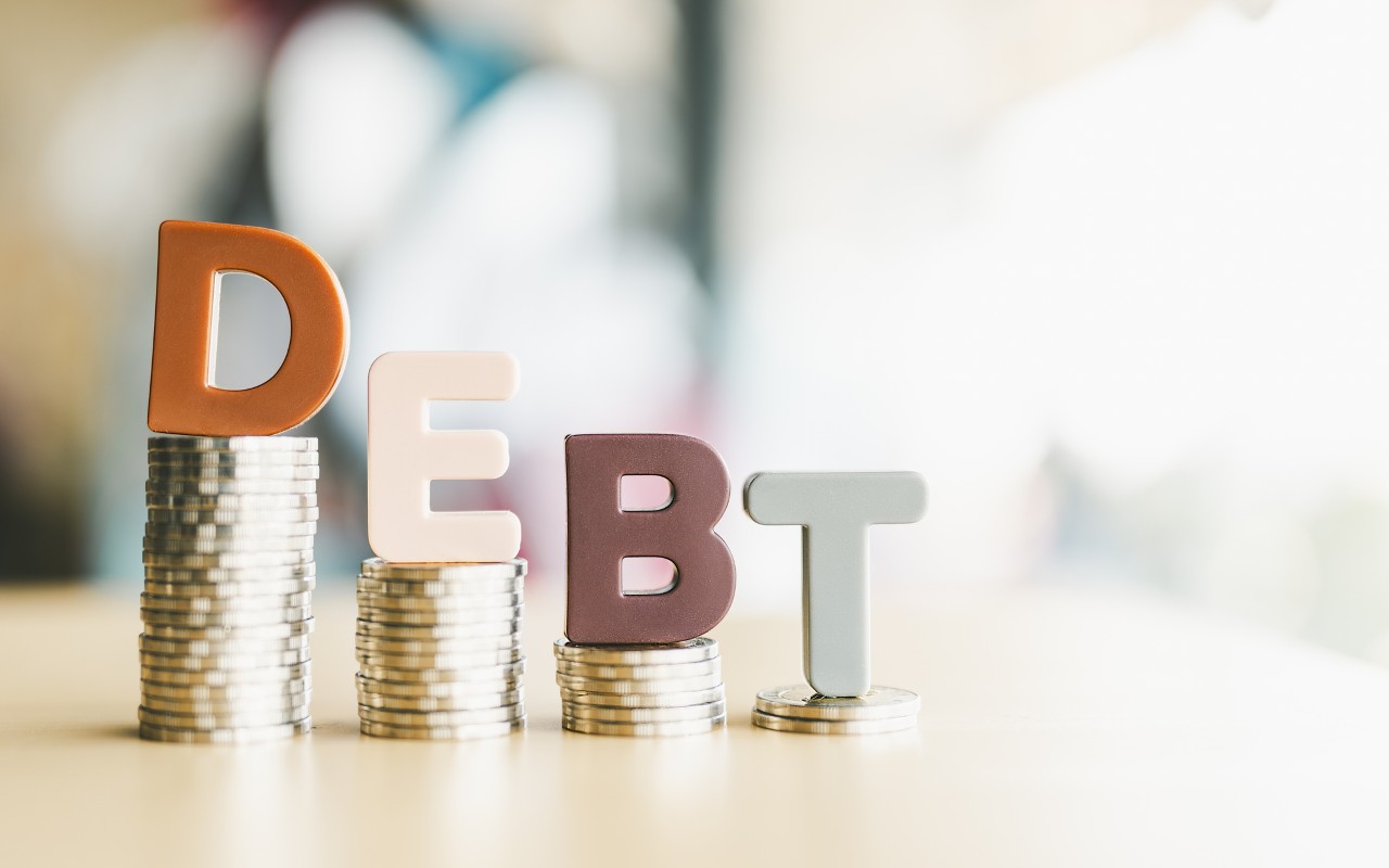 Debt letters on stacked coins