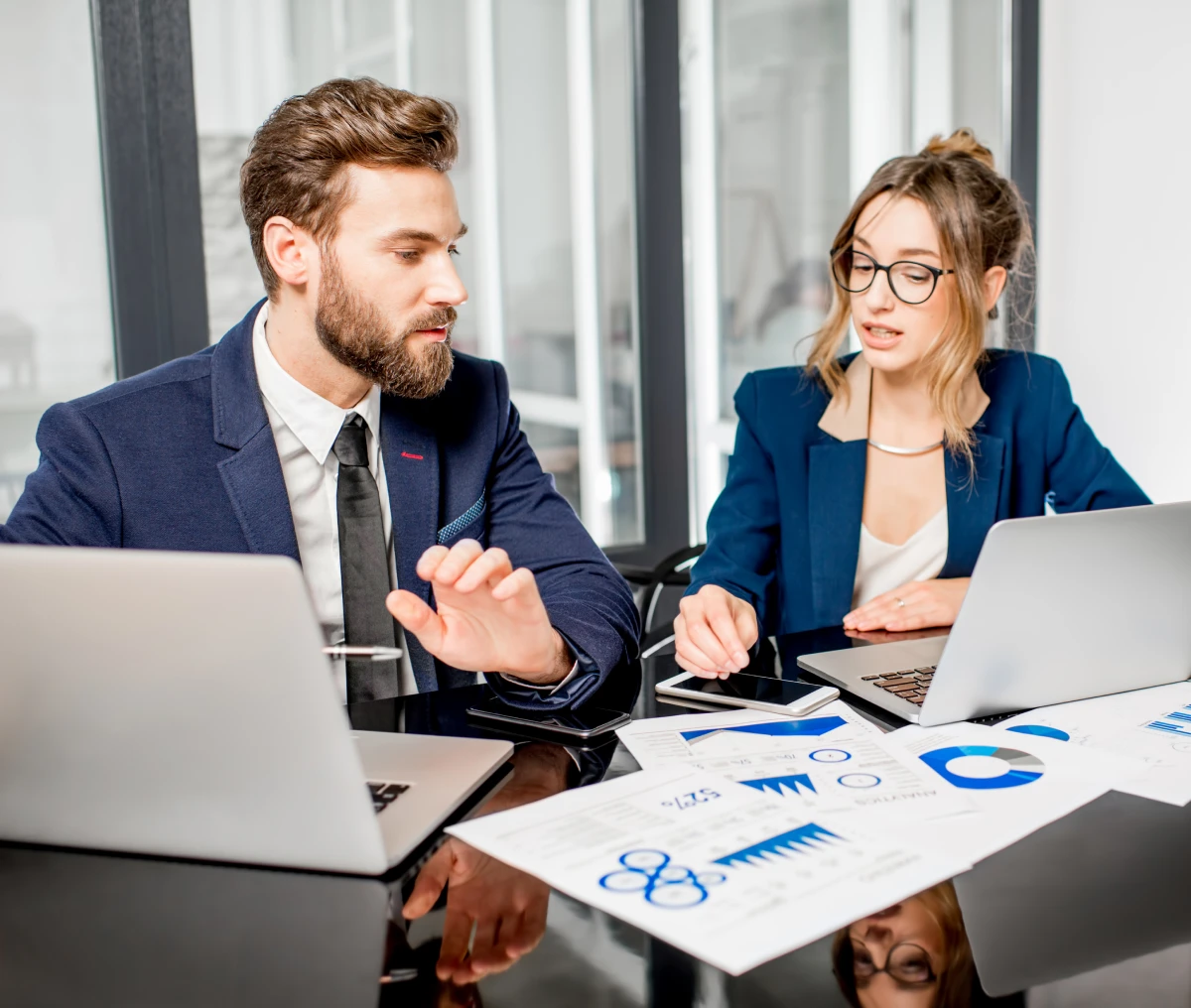 Business meeting with charts and laptops