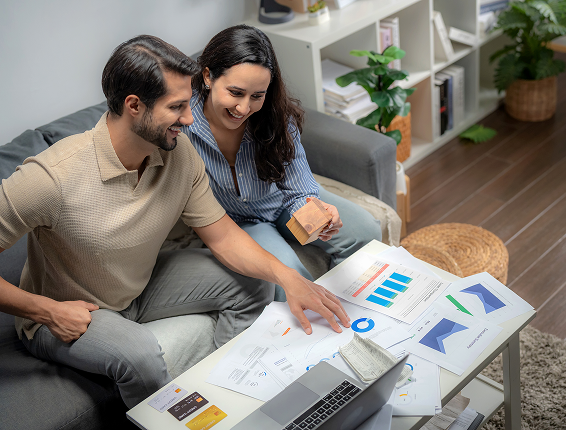Partners planning finances together in living room